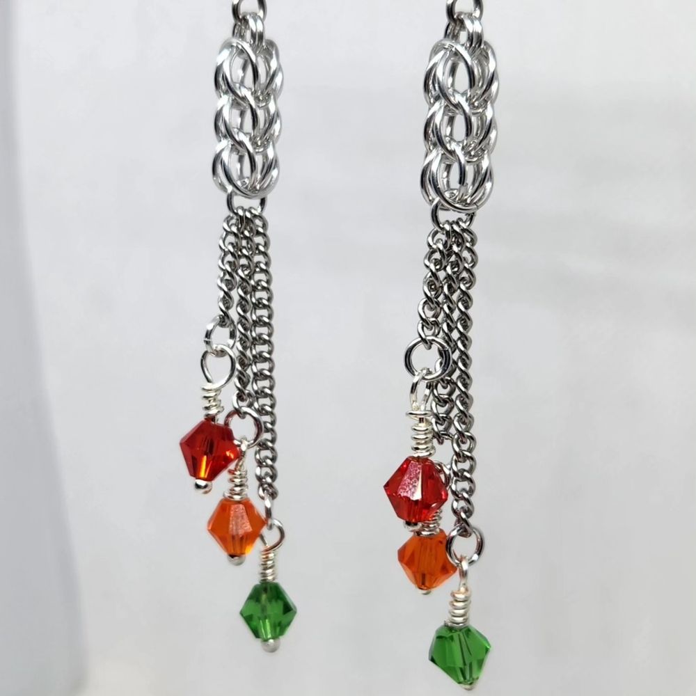 Silver chainmail and chain earrings with red, orange and green glass beads