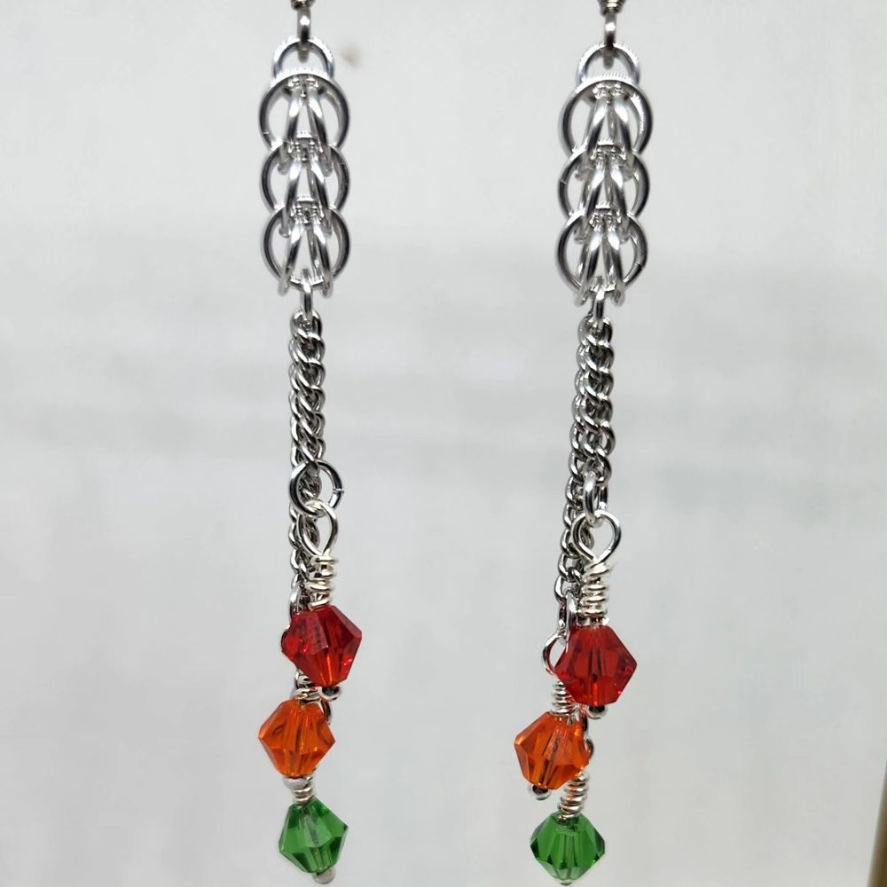 Silver chainmail and chain earrings with red, orange and green glass beads