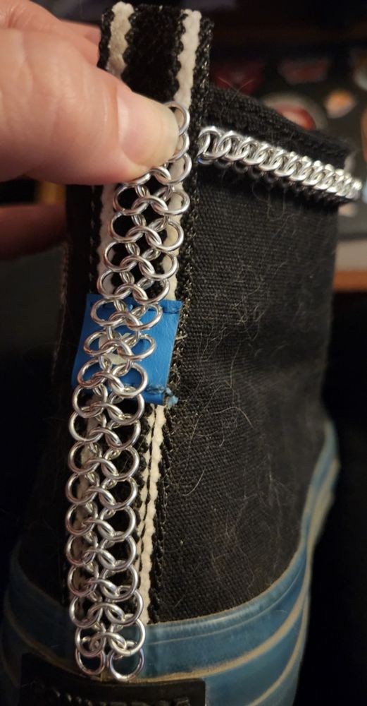 Silver aluminium chainmail chain on a black shoe