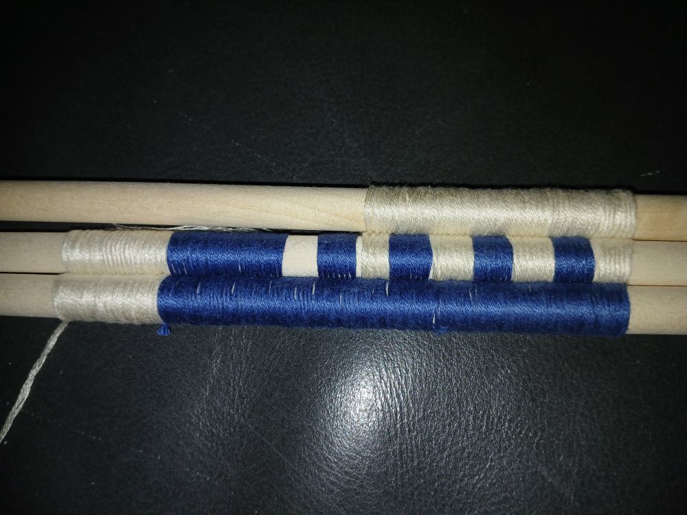 A sampler of possible binding techniques for rods. Using blue and white embroidery thread.