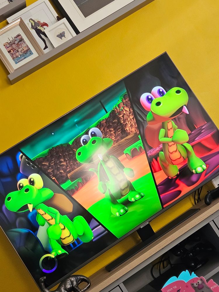 Wonky picture of a tv screen showing the loading screen for the videogame Croc with three pictures of a little animated crocodile.