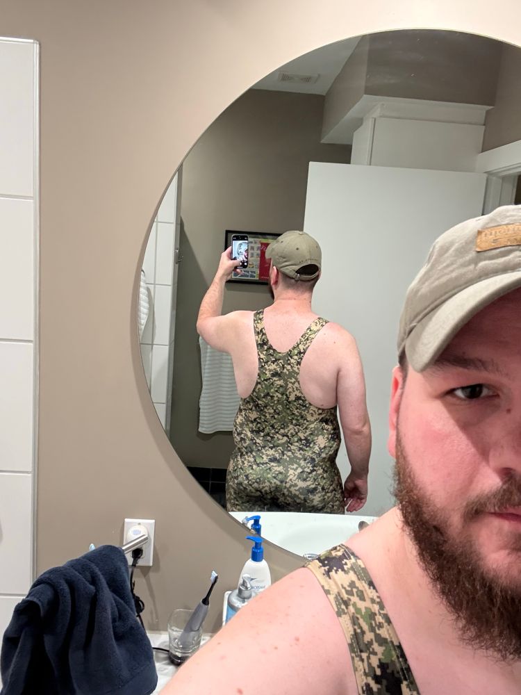 Mirror selfie of me in a camo singlet from the back 