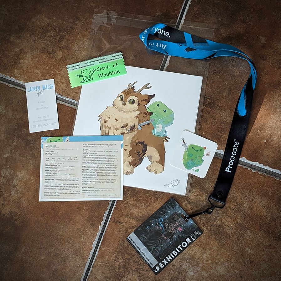 photo of LBX badge and swag-- a set of signed prints, ribbon, and stat card for Woubble from @laurenwalshart.bsky.social