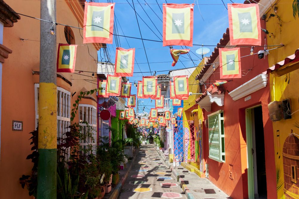 Colourful pedestrianised street with flags hanging across from one side to the other