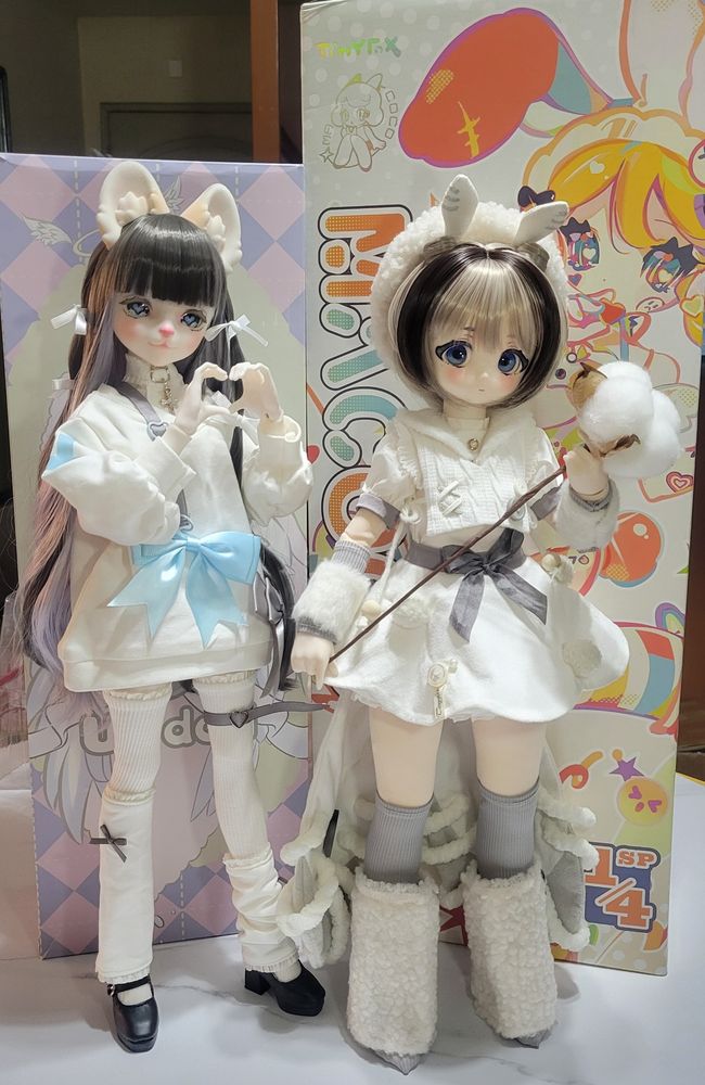 1/4 scale ufdoll bjd with cat ears standing next to a 1/4 scale tinyfox mjd with a cottonball staff and crafted moth antennae on her hat and crafted moth wings on her skirt she's also super cute!!!