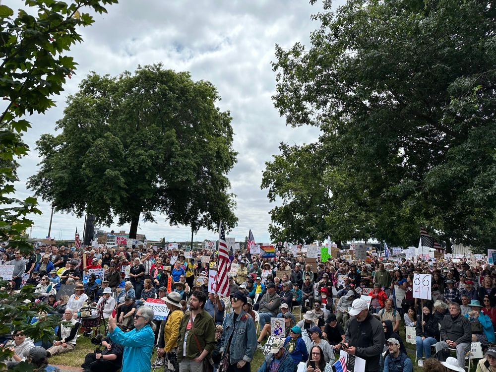 Crowd of people holding signs