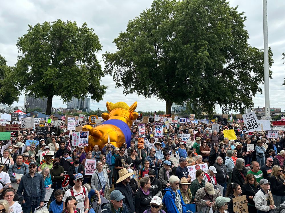 Crowd of people holding signs