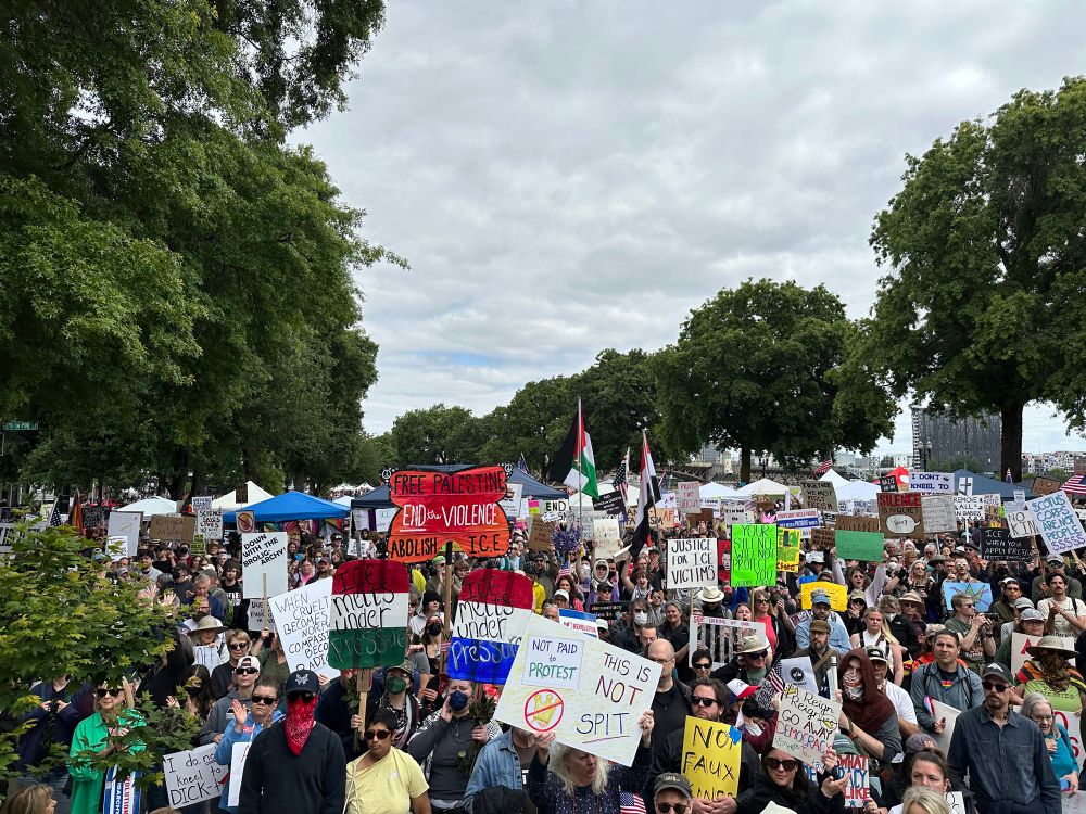 Protest crowd holding anti-Trump signs 