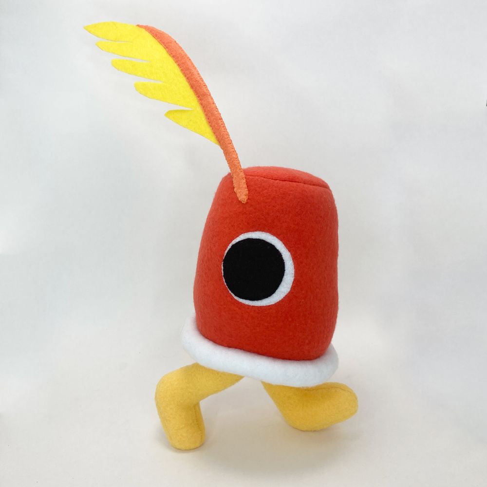 a photo of a plushie based on the Cuptains from Deltarune chapter 4. It's in a walking pose.