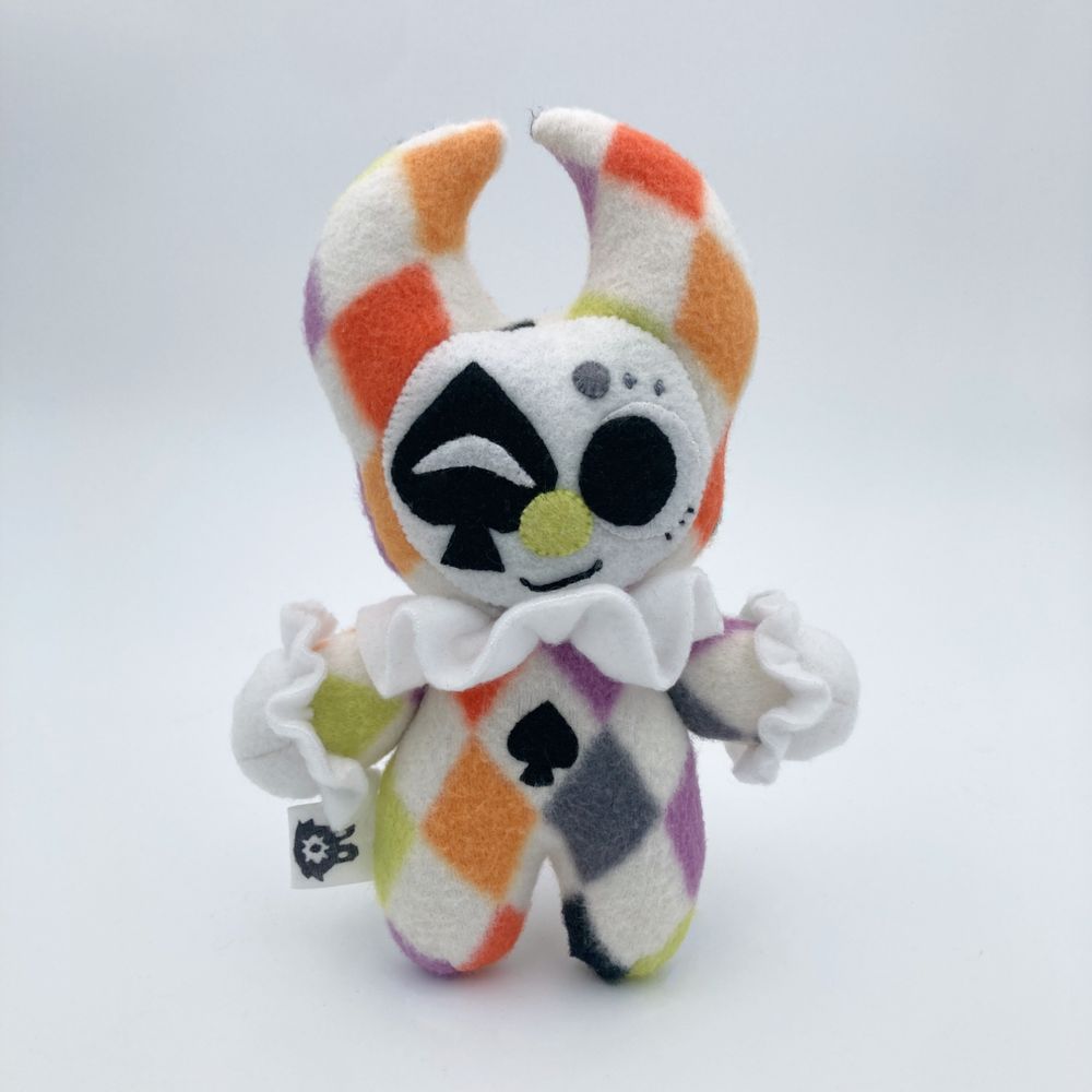 photo of a clown plushie with colored diamond patterning, with a spades motif.