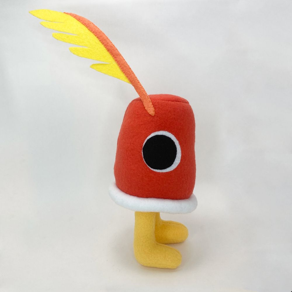 a photo of a plushie based on the Cuptains from Deltarune chapter 4. It is standing straight up.