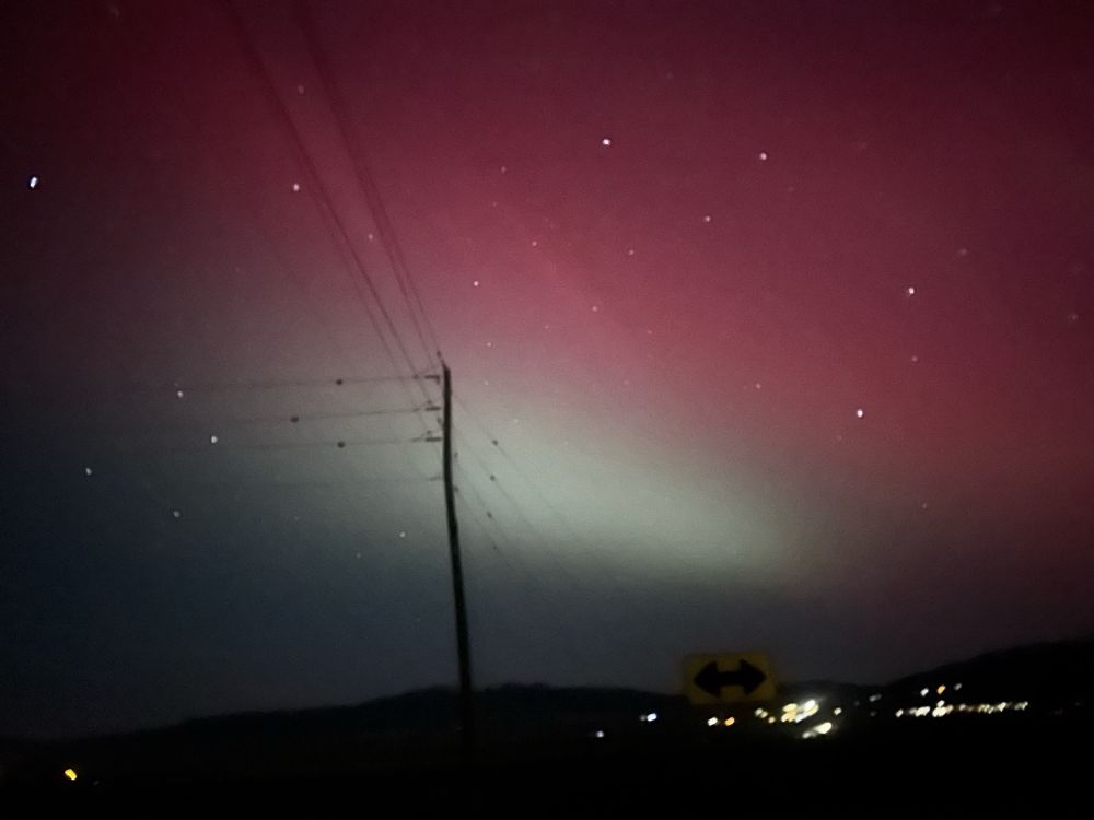A photo pointing south showing the aurora was in fact 360 degrees around me. The greens and reds are pale, but distinct