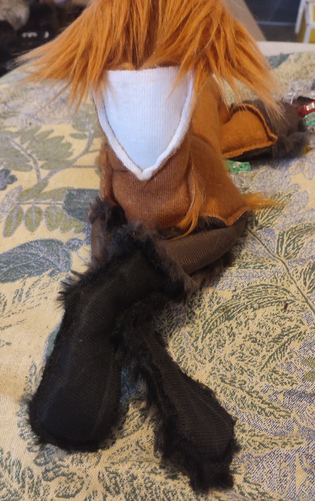 A work in progress plush. It is a quadrupedal, rusty coloured animal with long dark legs and a white throat patch.