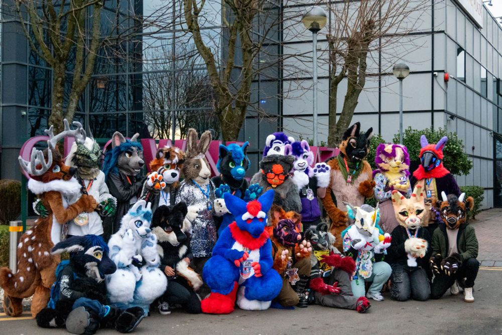 A group of fursuiters arranged in two rows. I am at the front in the middle in my Rot fursuit.