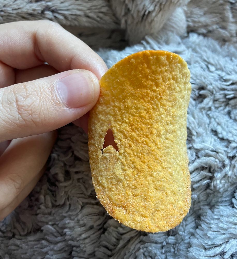 Pringles chip with a starfleet delta shaped hole in it