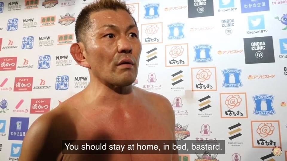 Minoru Suzuki with the quoted text "You should stay at home, in bed, bastard"