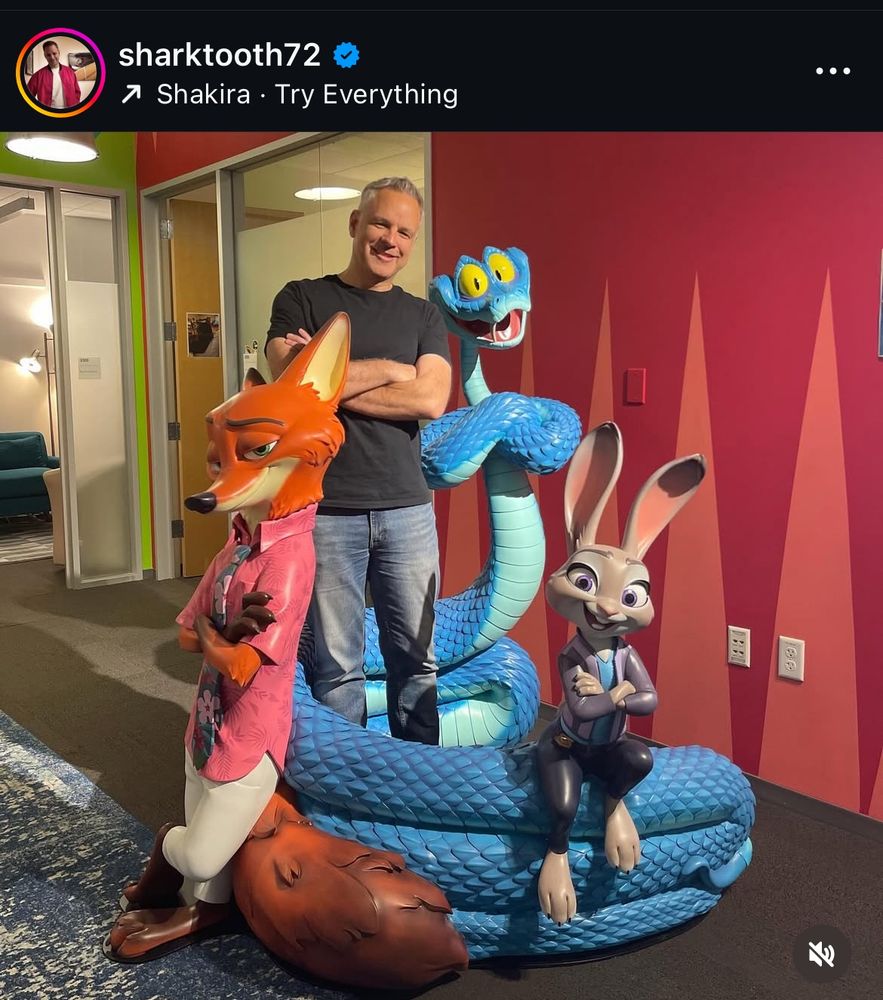 Instagram post of a Disney storyboard artist posing with Zootopia 2 displays
