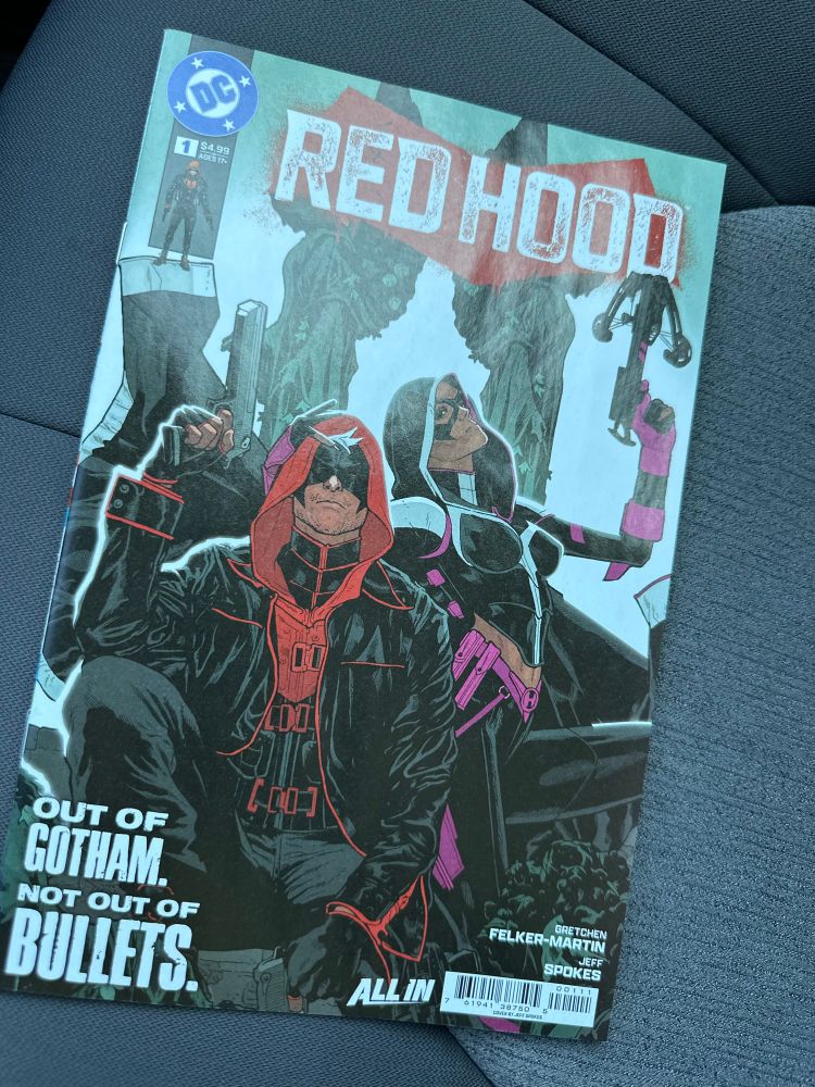 A copy of Red Hood (2025) #1 sitting on a car seat