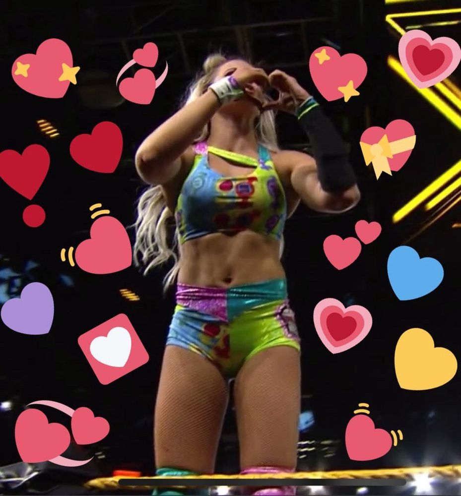 candice lerae surrounded by hearts, making a heart hand!
