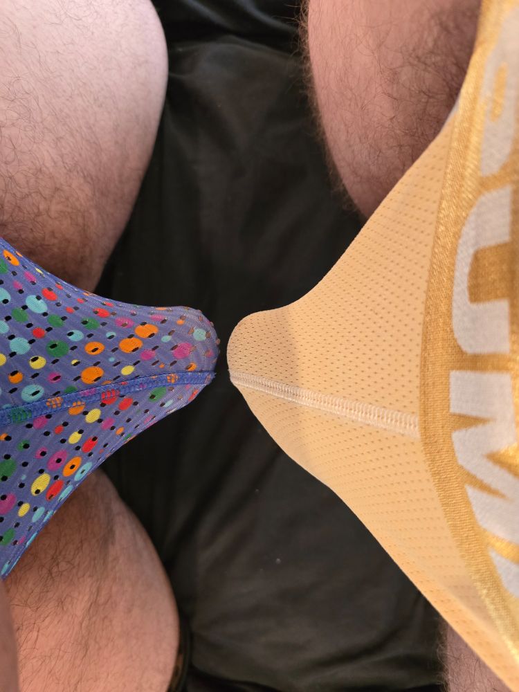 Two bulges from two canines nearly touching in yellow and multi colored underwear