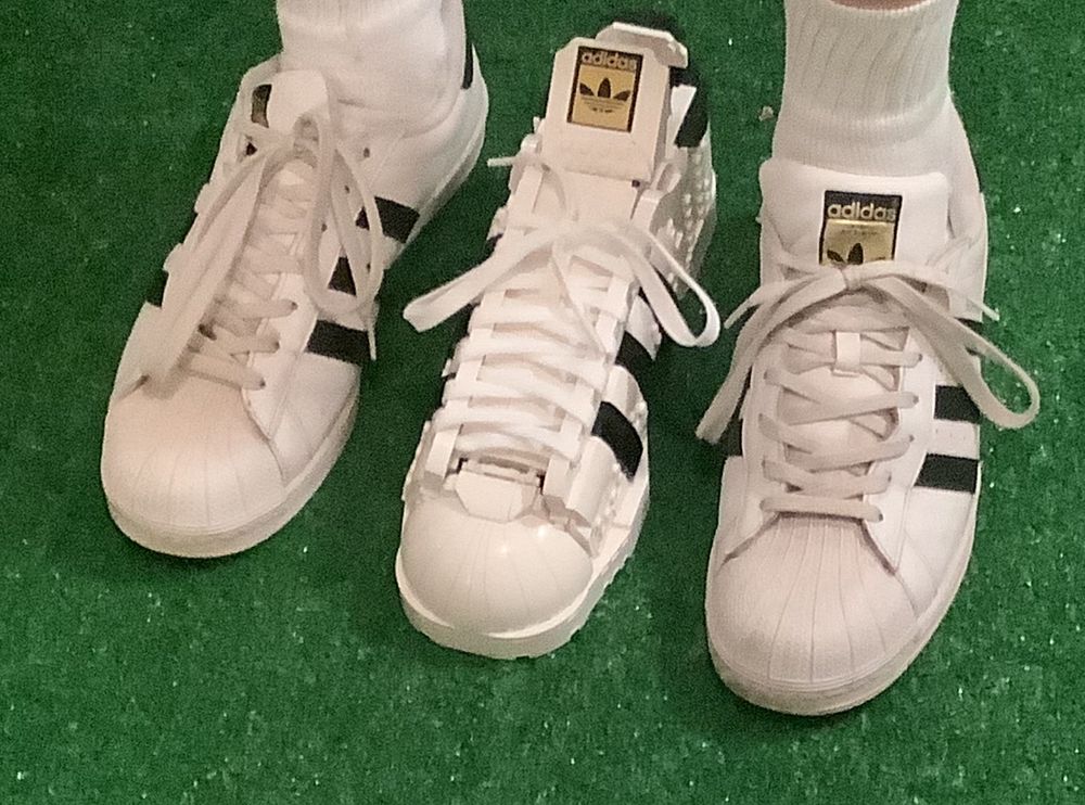 3 adidas classic kicks (shell toe, white with black stripes) - 1 left shoe, 1 right shoe and one LEGO right shoe.