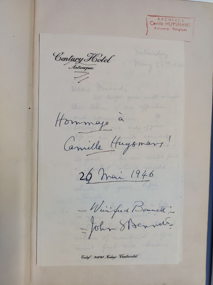 A handwritten note, on paper of the Century Hotel in Antwerp, saying "Hommage à Camille Huysmans! 26 mai 1946" and signed "Winifred Bennett" and "John S Bennett".