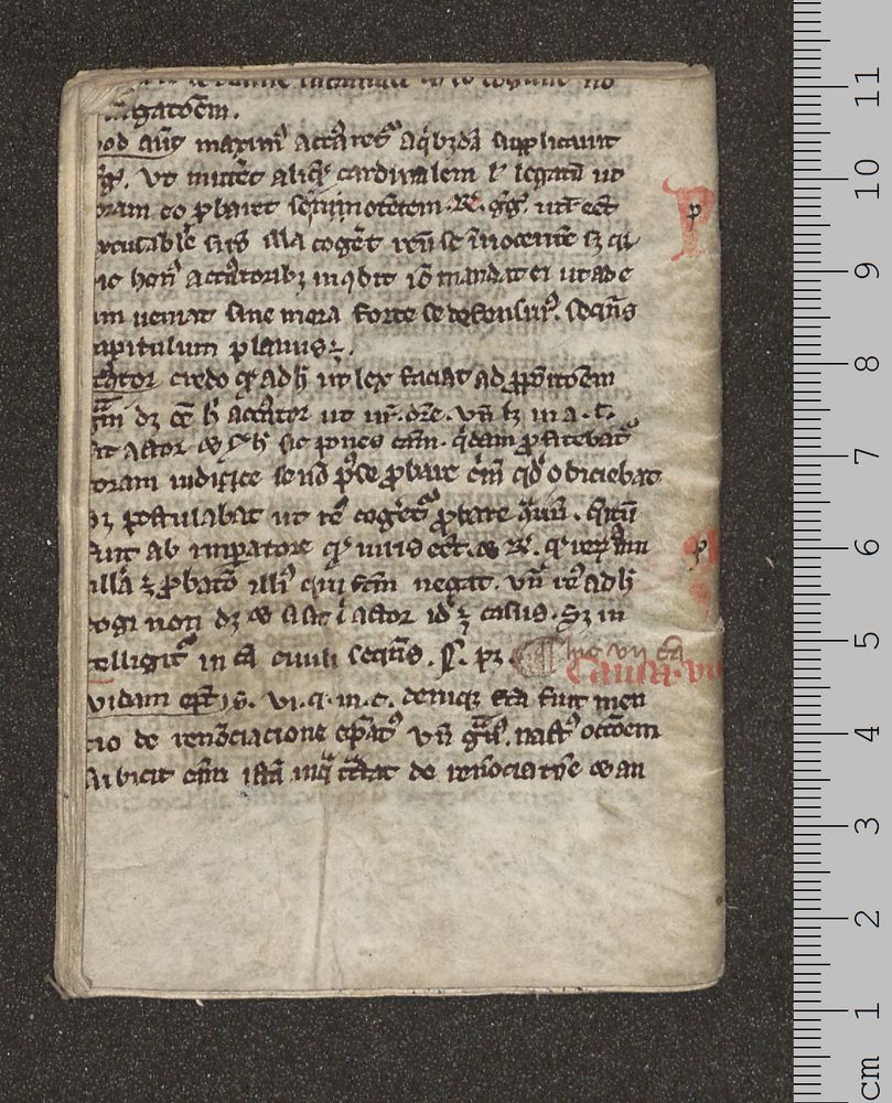 The back of the almanac, showing a fragment of parchment with handwritten text. Some larger words are written in red ink.