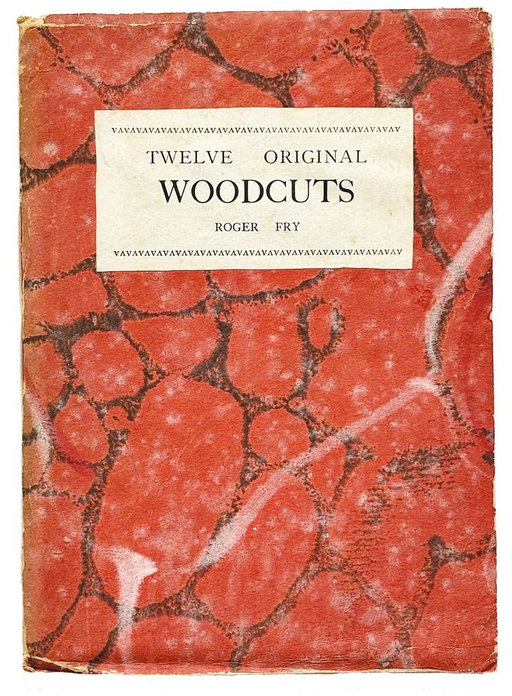 Cover of 'Twelve original woodcuts' by Roger Fry. It is a red marbled paper with a white label showing the title.