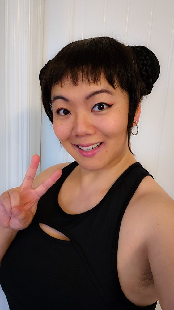 Photo of JWo cosplaying as Zoey from the movie K-Pop Demon Hunters doing a peace sign