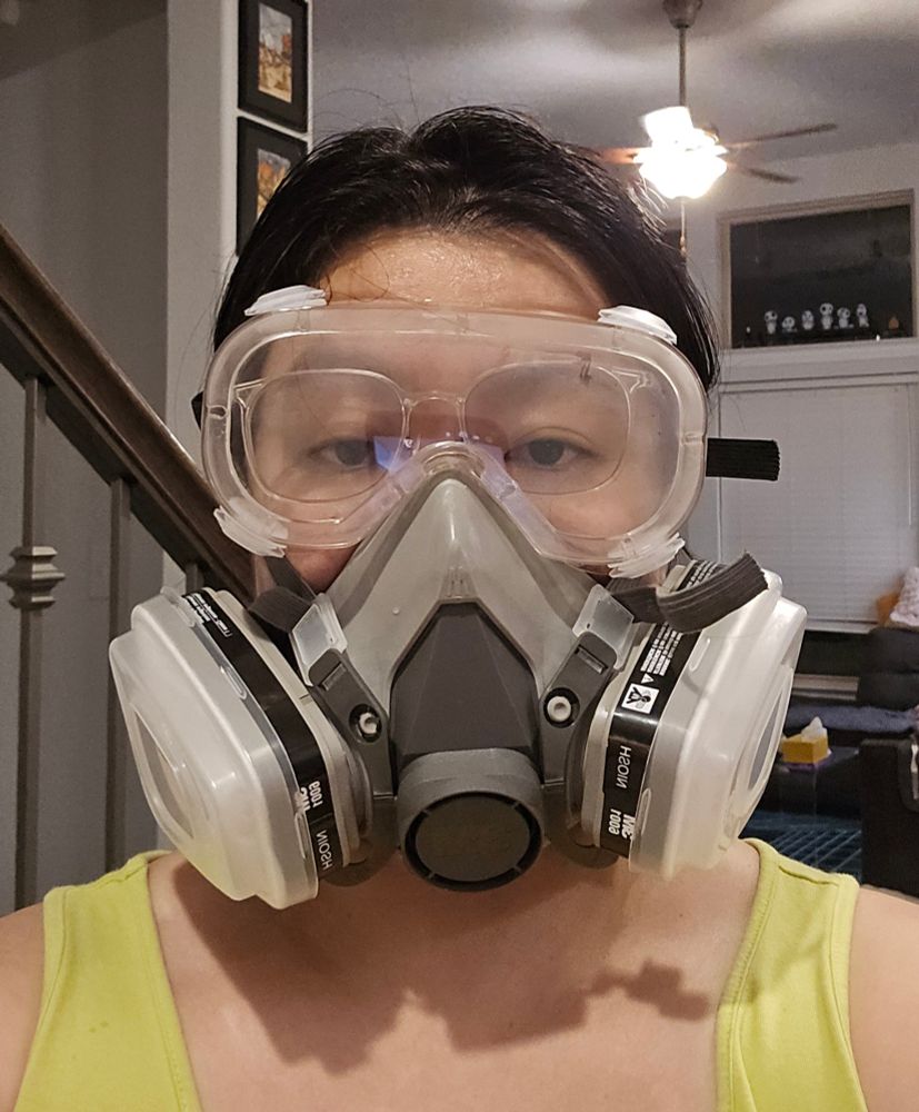 Selfie of JWo wearing a respirator and glasses under clear safety goggles. The safety goggles look slightly foggy as if steam has built up underneath.