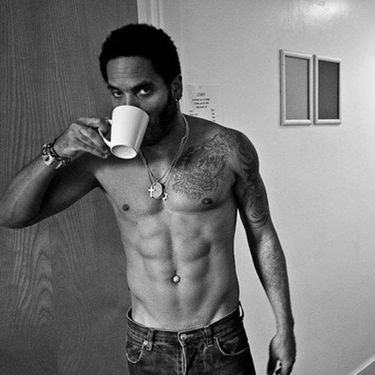 Lenny Kravitz drinking from  a mug, topless revealing rather a fine body