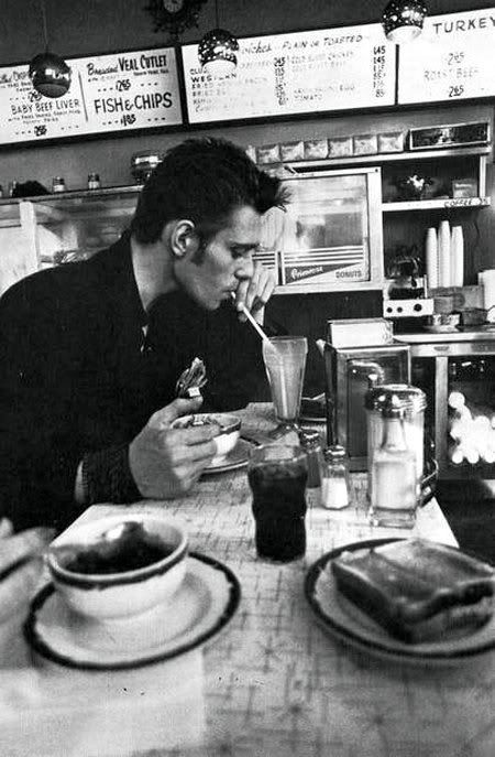 Image of Paul Simonon from The Clash in a cafe or diner