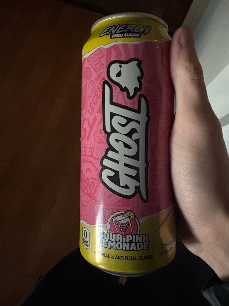 Me holding a pink (sour pink lemonade) ghost drink