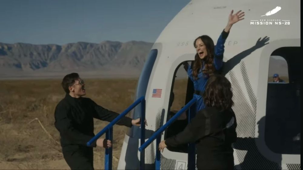 Emily Calandrelli – the aerospace engineer/children’s author/Science communicator/former Brooke Owens Fellowship executive – waves with a joyful expression as she steps out of the capsule that she just flew to space.