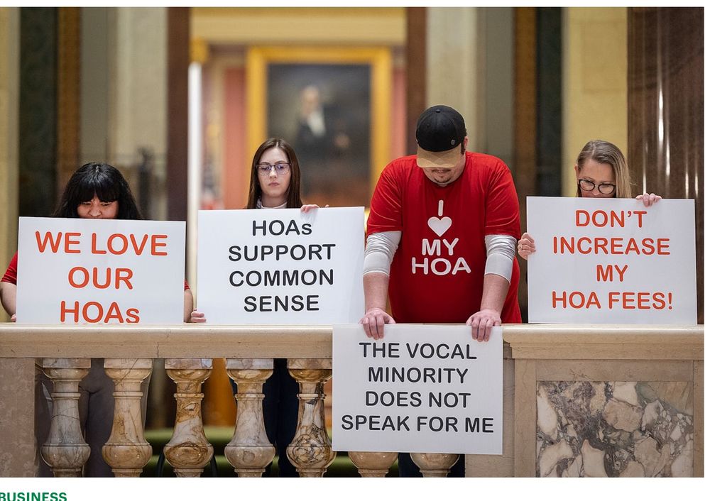 Protesters at the Minnesota capitol defending Homeowners Associations. One wears a red “I heart my HOA” tishrt. 