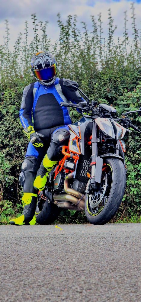 Biker sitting on the side of his bike