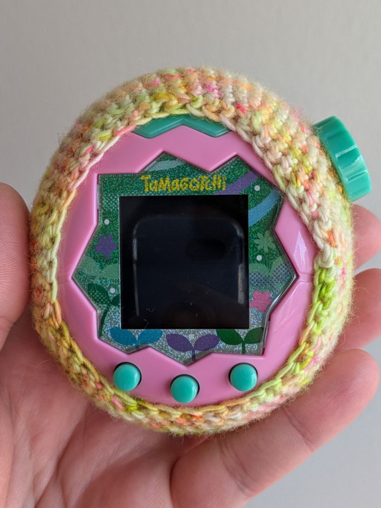 Tamagotchi Paradise in a yellow crochet vase. Front view