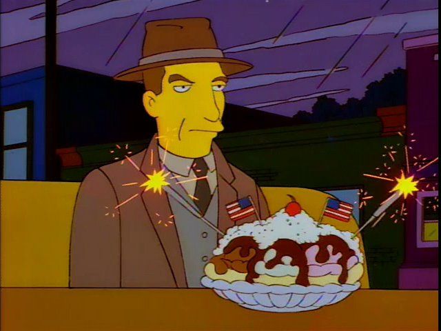 Simpsons character Rex Banner sitting sternly in front of a banana split with sparklers
