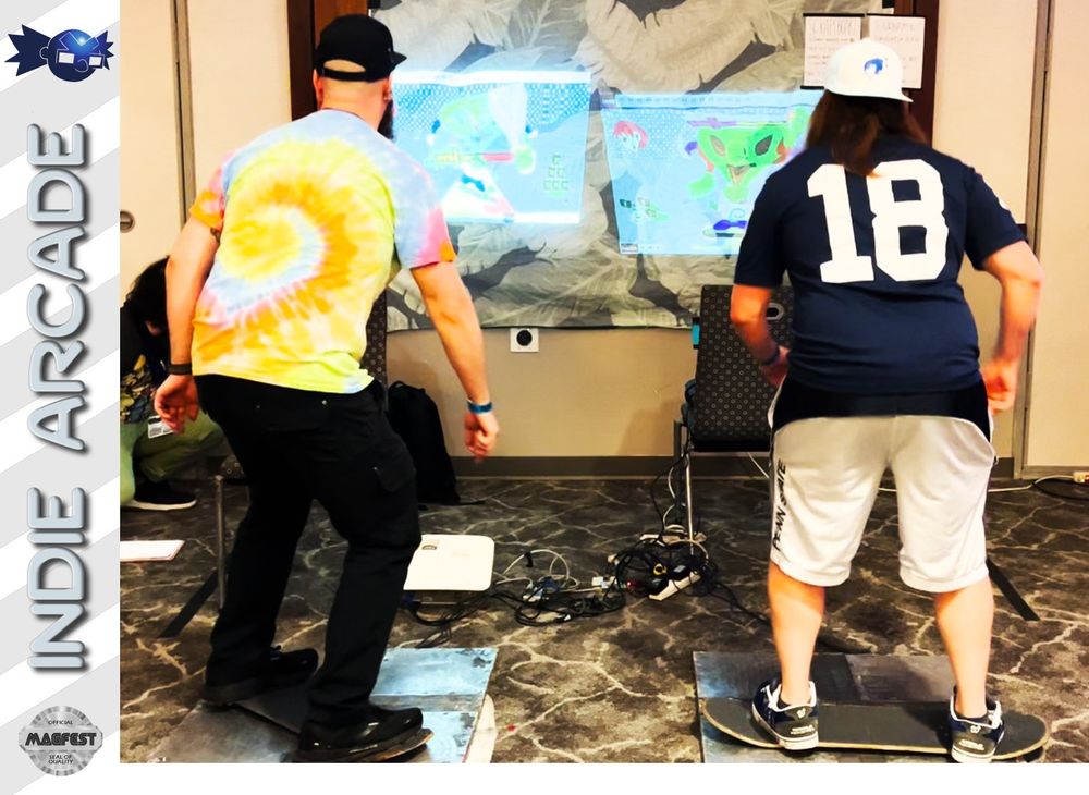 two people standing on wheel-less skateboard decks atop metal platforms, playing the game Scrapeboard, which is projected on the wall in front of them