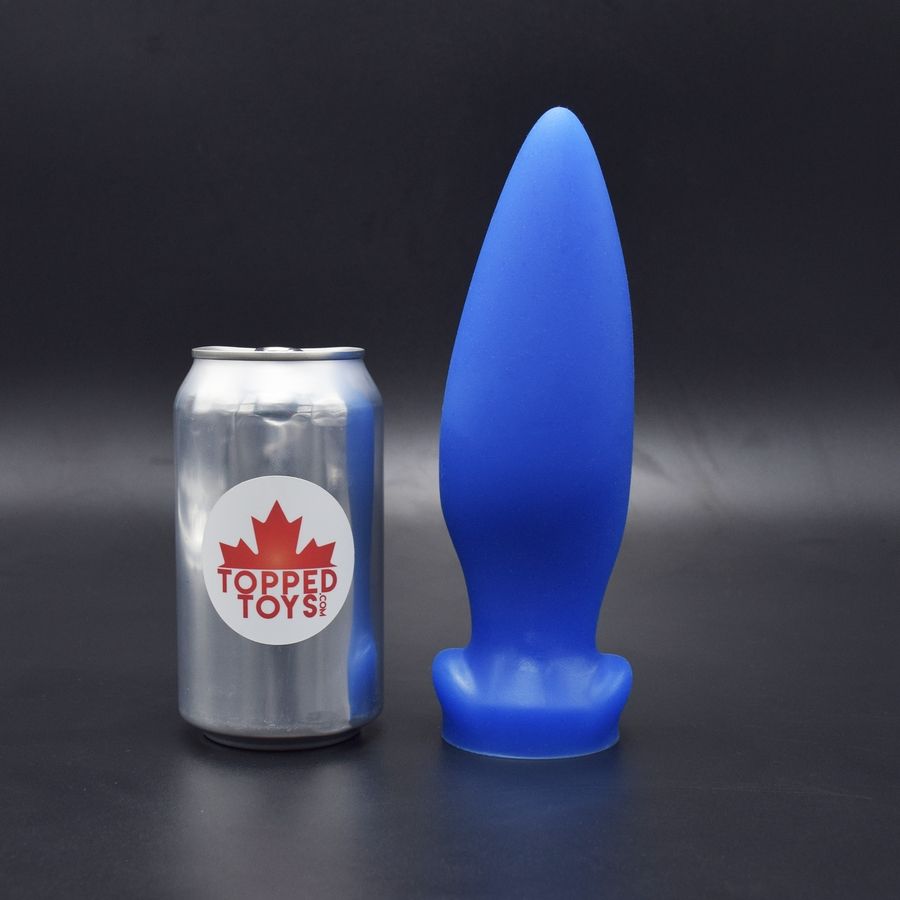 A picture of the tipped toy plug the mare maker 60. It is a vibrant blue and it's taller than a soda can by a significant margin