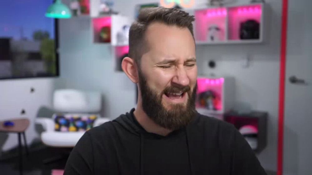 a man with a beard is making a funny face with his mouth open