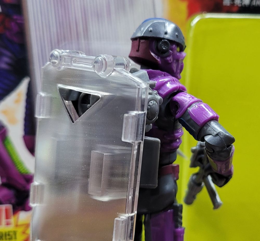 Image of shield attached to backpack of Ghost 