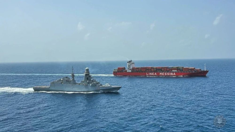 The Italian Navy Carlo Bergamini-class frigate Federico Martinengo escorts an Italian-owned cargo ship through the Red Sea.
