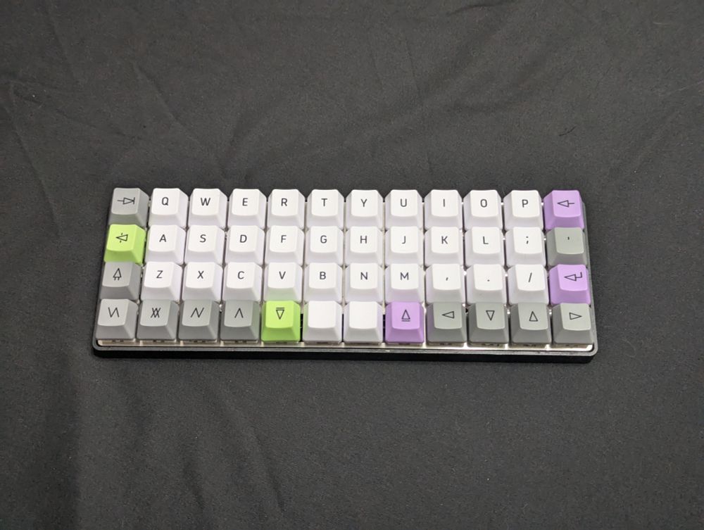 A photo of the massdrop x olkb Planck ortholinear keyboard with a split space bar