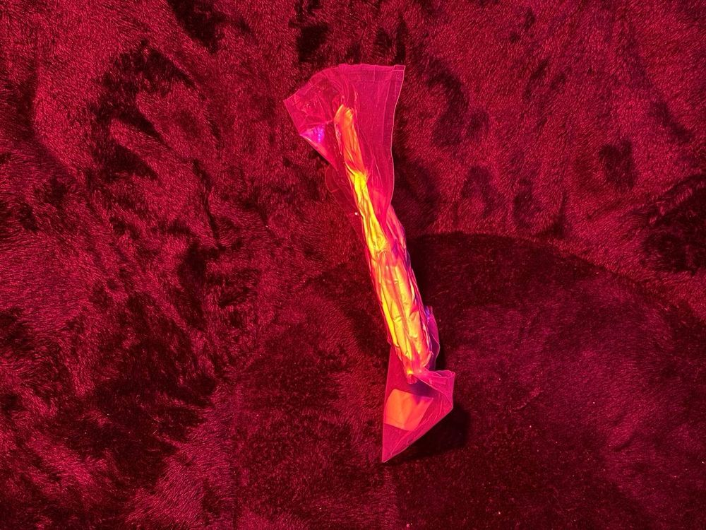 Sixe view of the pou pouch, also in deep red lighting.
