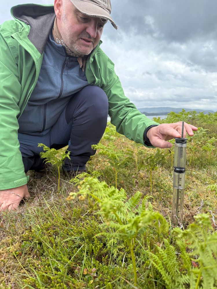 Attila Nemes from NMBU sitting in the field, demonstrativt soil water measurement equipment