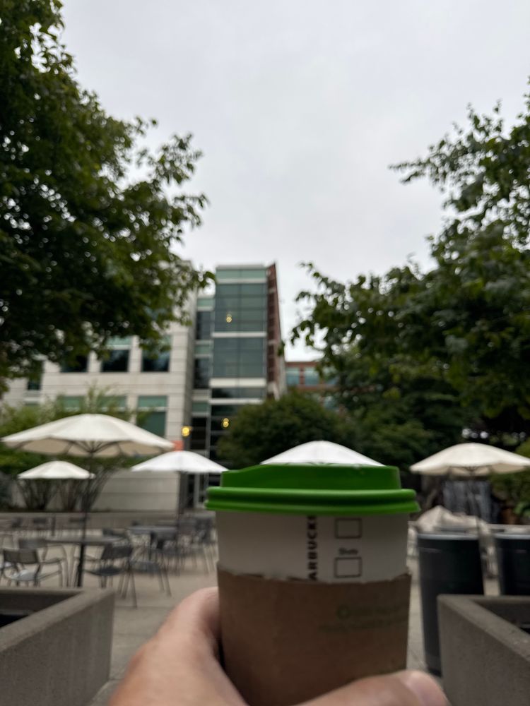 A latte in the middle of some Microsoft buildings. The skies are cloudy and gray.