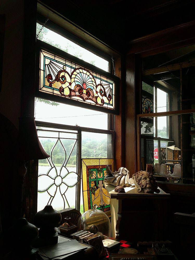 photo inside an antique store with stained glass windows on the inside 