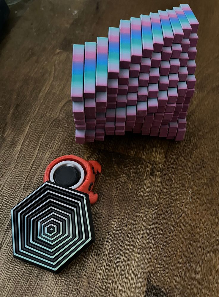 3 fidget toys- a hexagon, a crab spinner, & a cube thing that flexes 