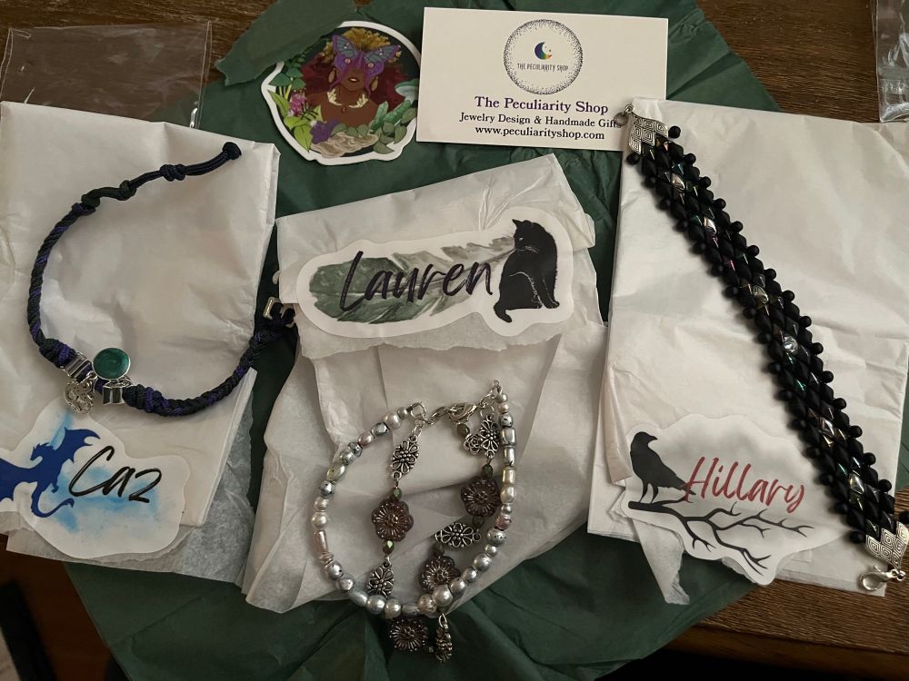 The packaging is now open and 3 gorgeous bracelets are sitting atop the white tissue paper